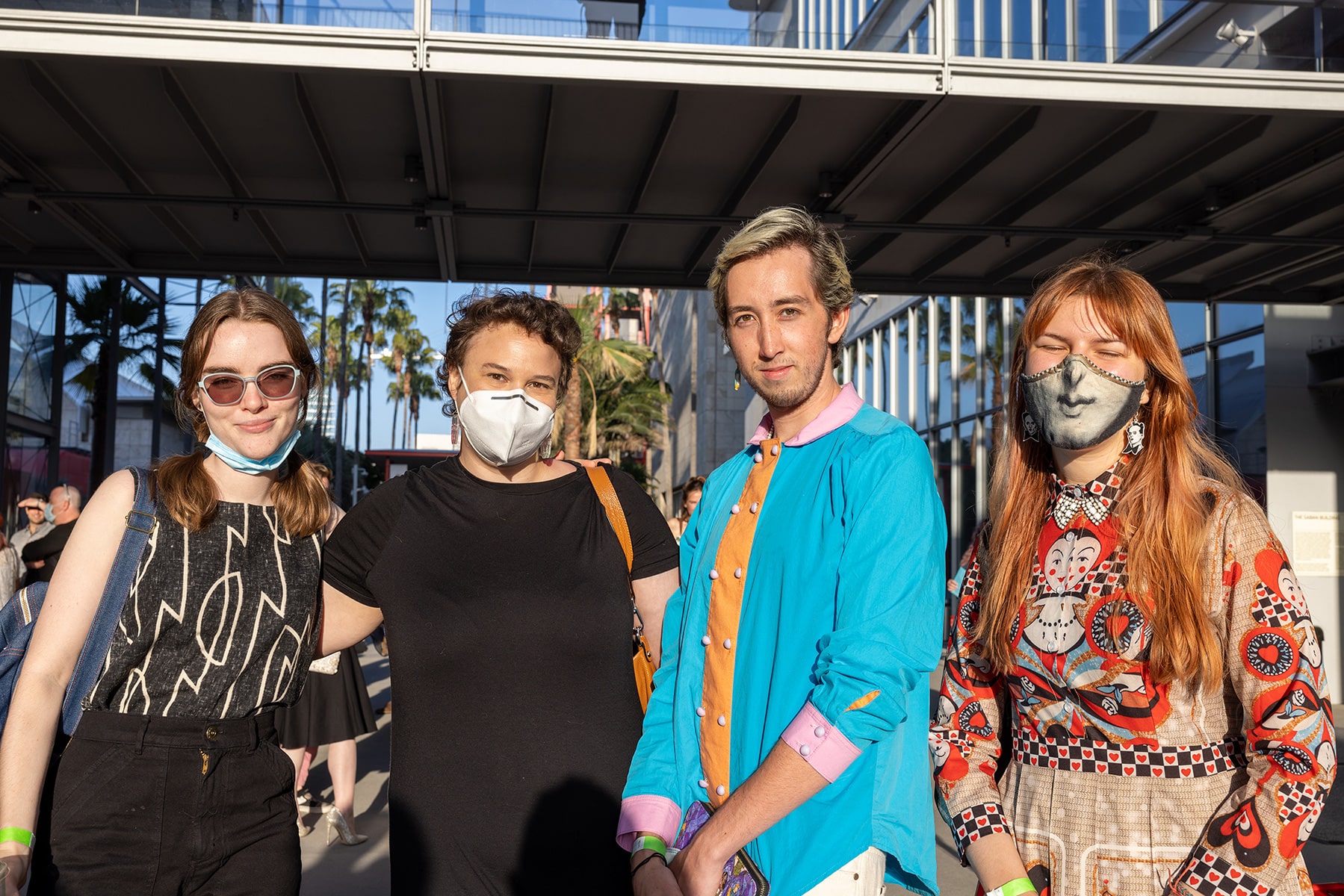 Four student filmmakers pose outside the Academy Museum entrance.