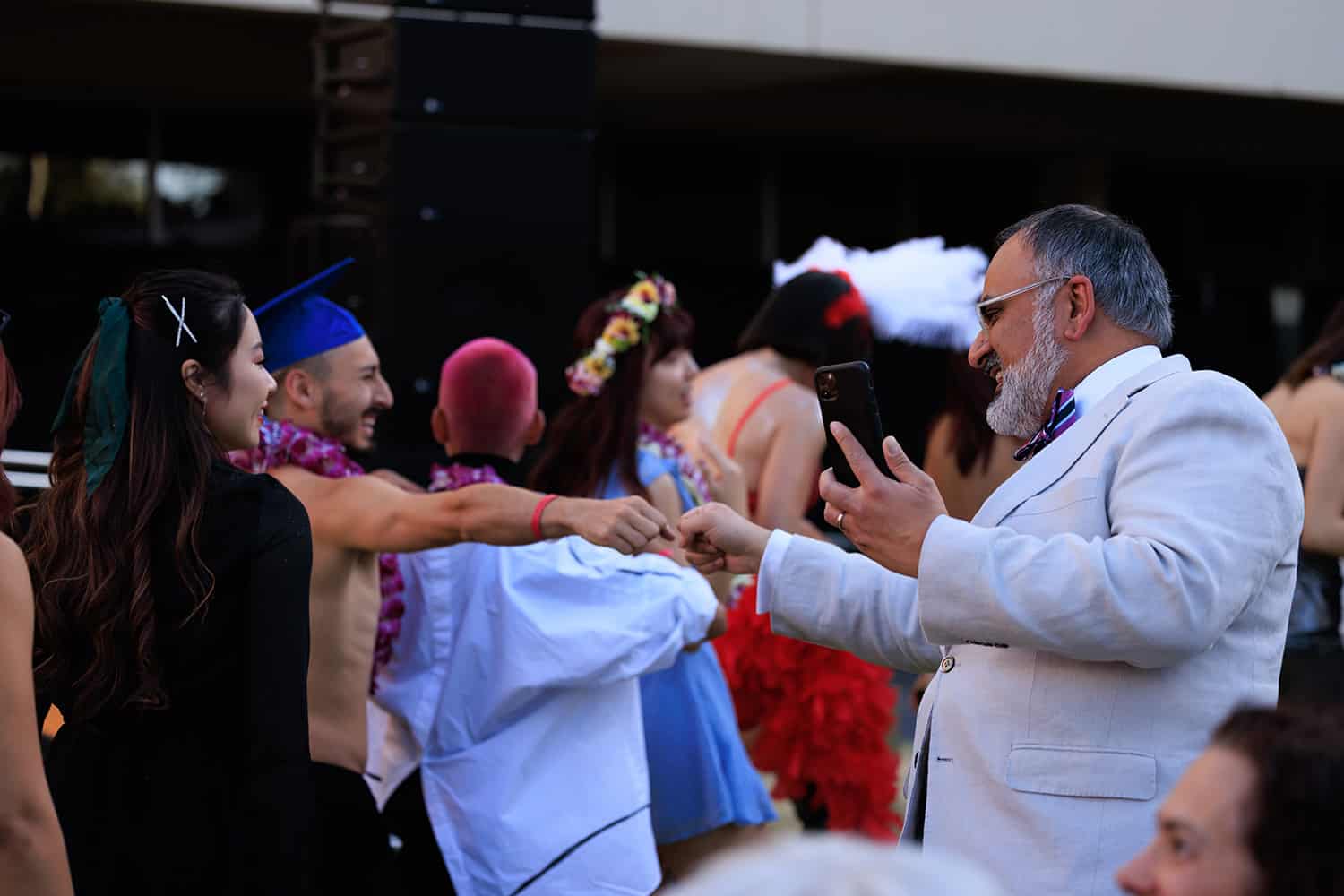 President Rajan shares a fist bump with a student during the procession.