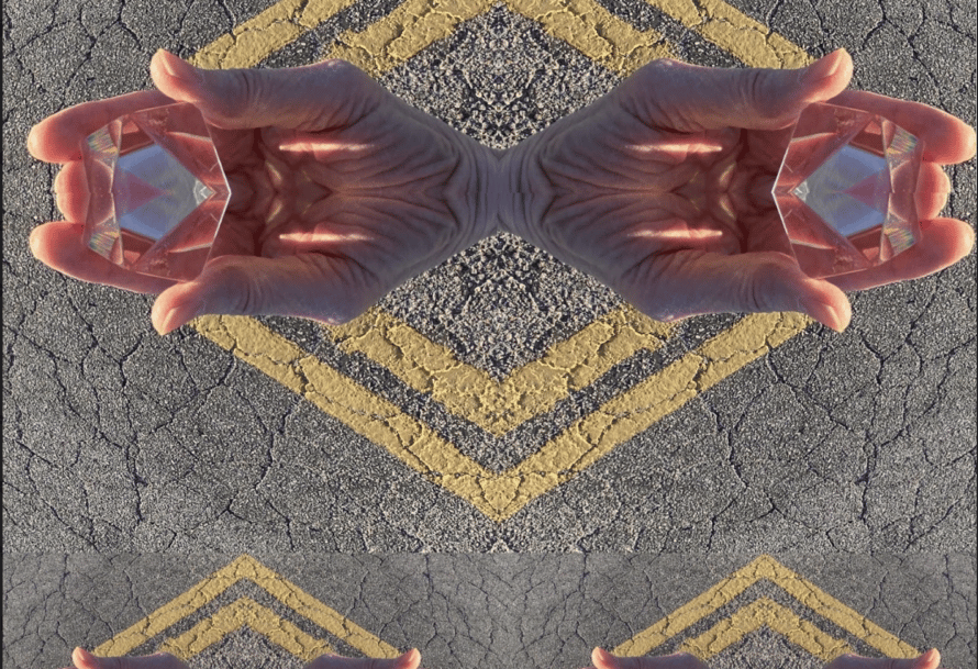 an image of hands holding a crystal; the hands are mirrored in a pattern