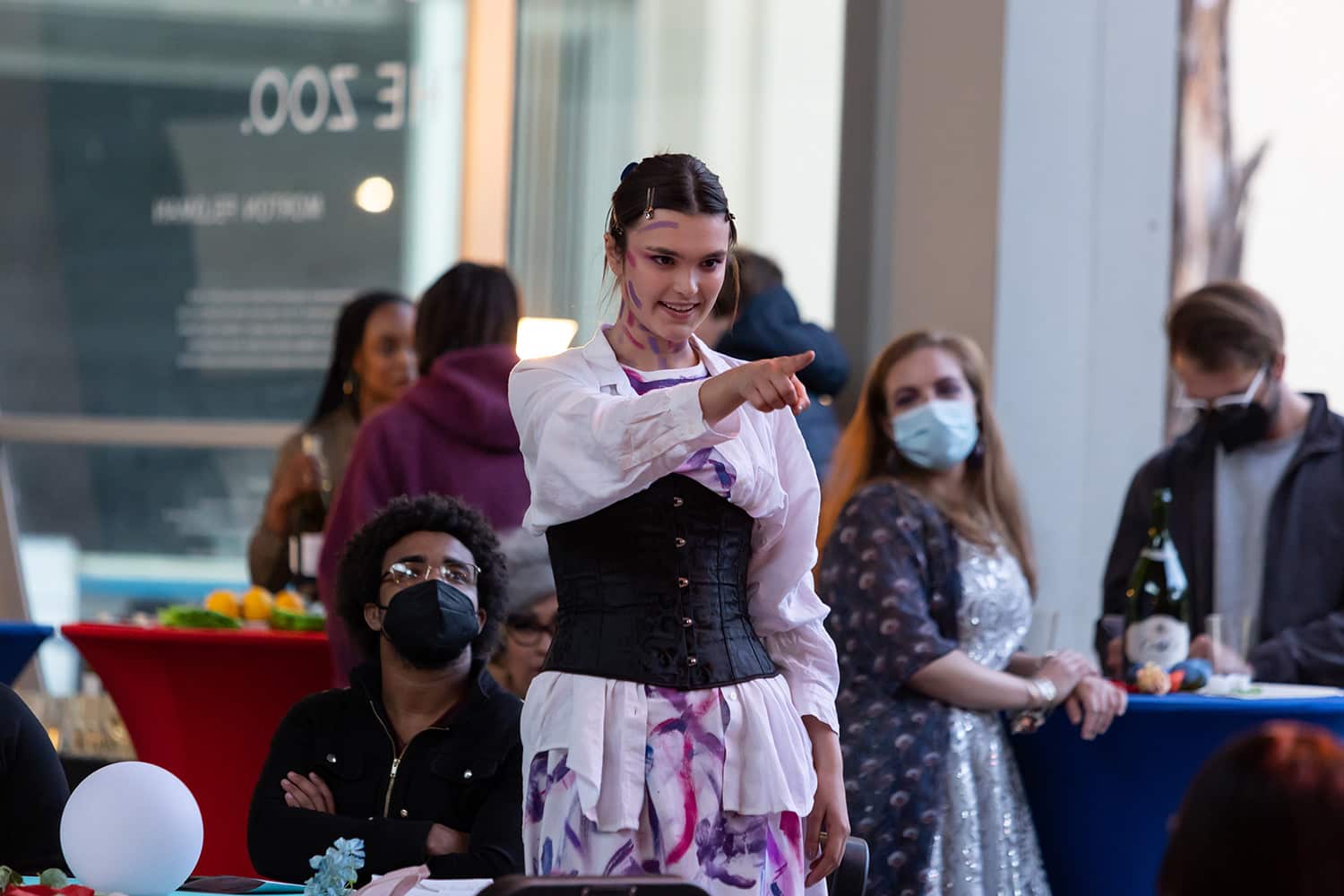 A costumed student points dramatically.