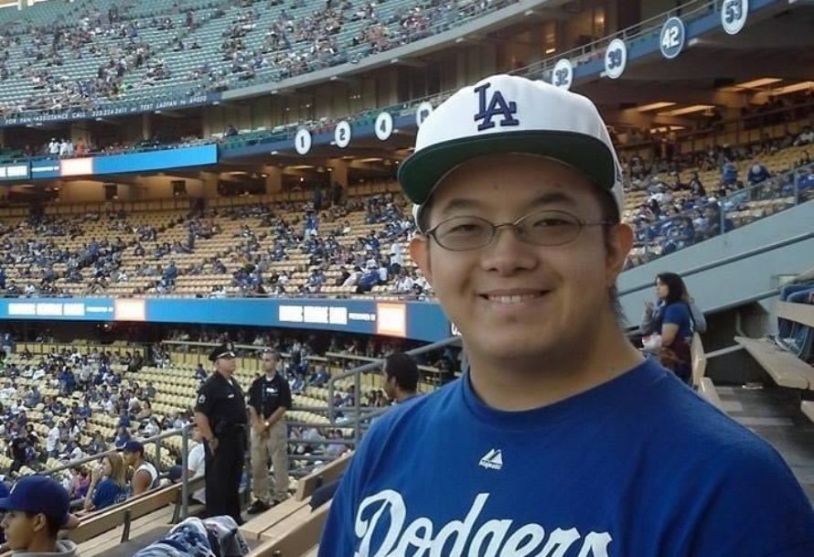 picture of man in a baseball jersey and hat enjoying the Dodgers game