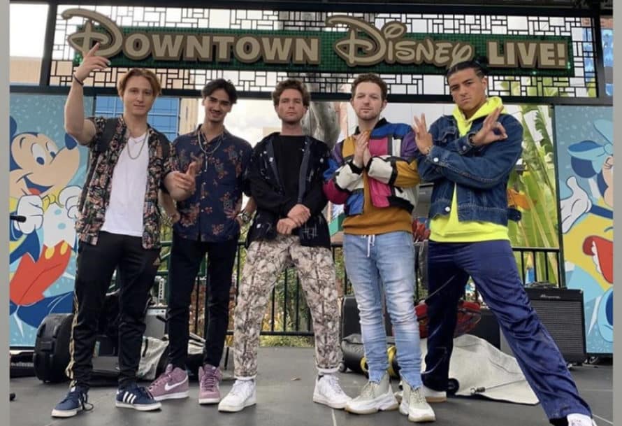 group of young men standing confidently on a stage