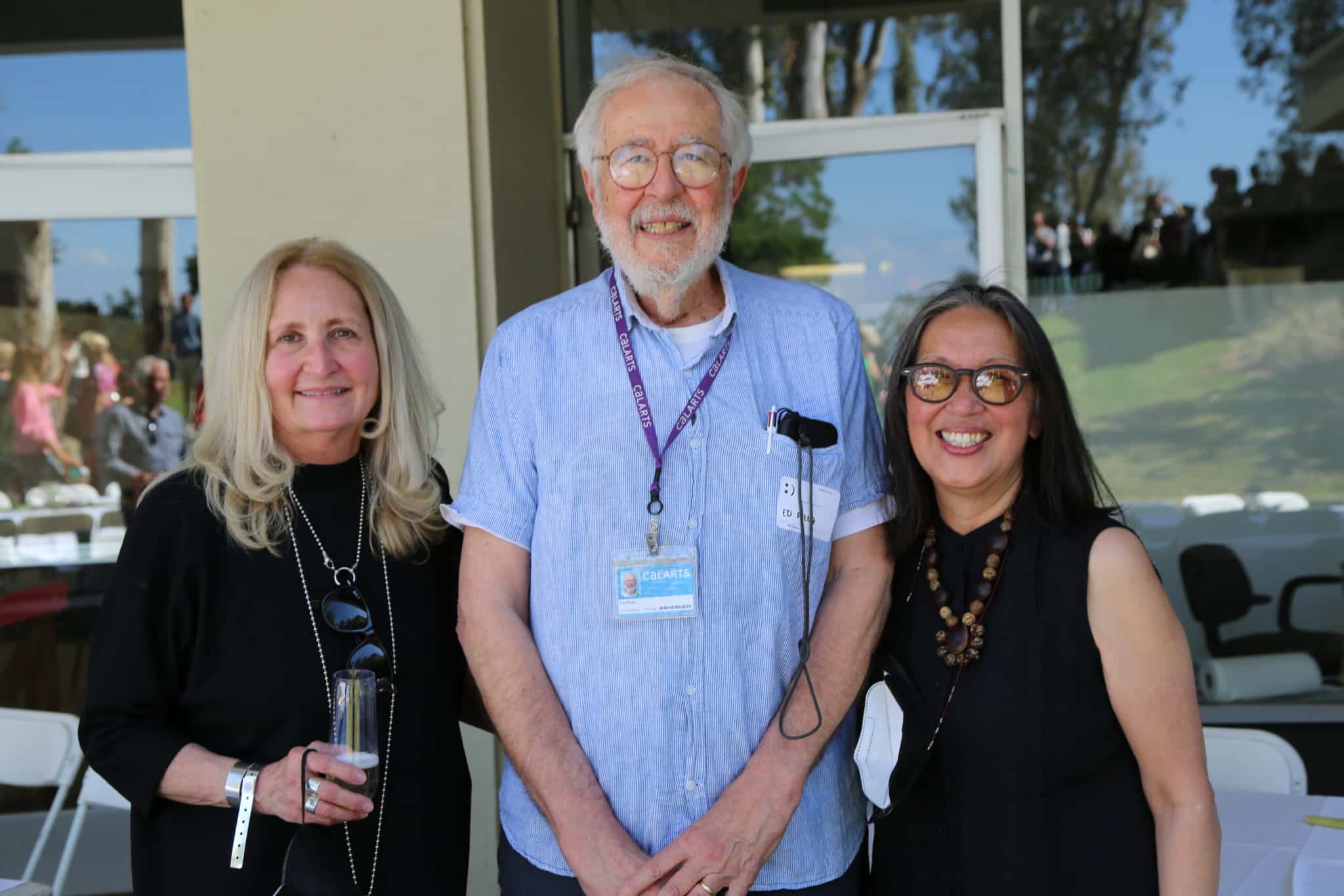 three people smiling at the camera