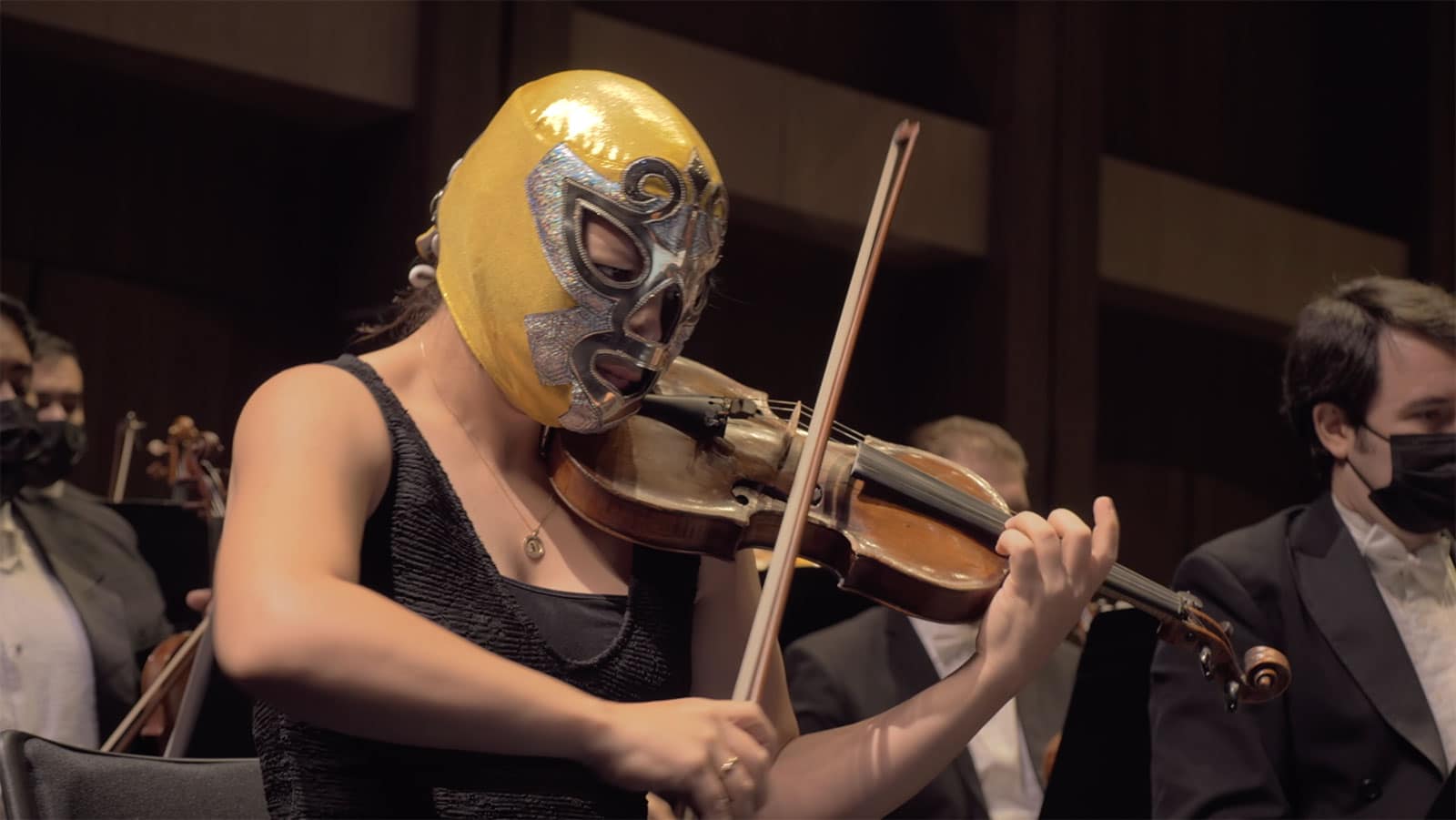 Violinist in gold and silver luchador mask