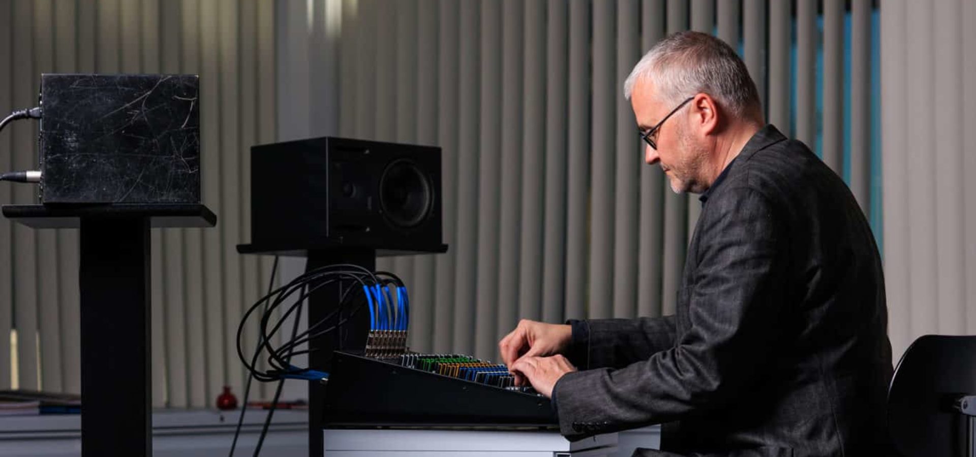 Dean Straebel seated, working at mixing console