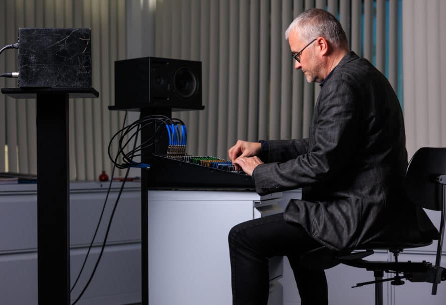 Dean Straebel seated, working at mixing console