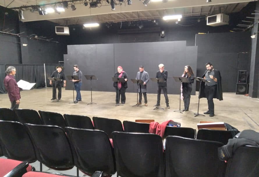 Performers rehearse on a stage